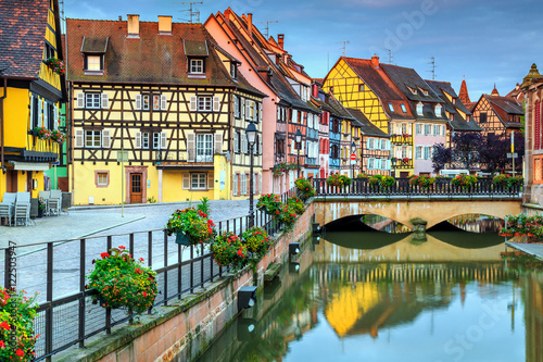 Typical medieval half-timbered facades reflecting in water,Colmar,France