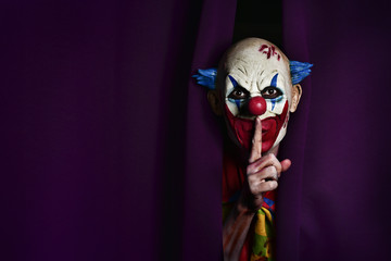 scary evil clown asking for silence
