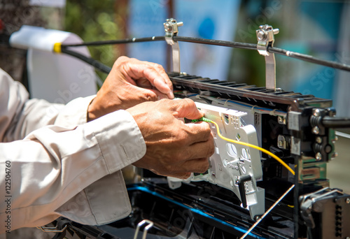 Technicians are install cabinet on fiber optic cable.