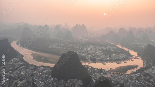 Breathtaking aerial view over beautiful karst mountain landscape and Li River covered with haze or fog at sunset in Yangshuo County  China