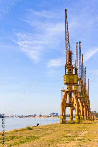 Porto Alegre port cranes with blue sky.