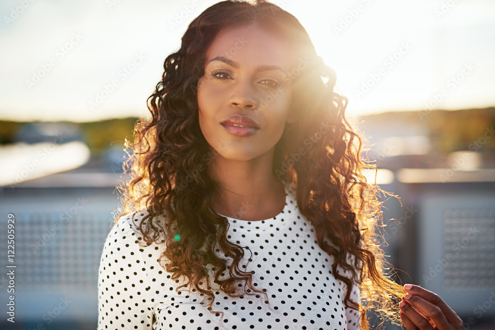 Fototapeta premium Dreamy young woman backlit by the rising sun
