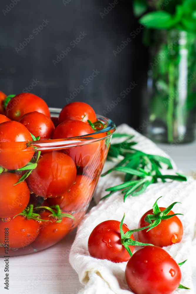 Tomatoes in water, cherry tomatoes on a light background, selective focus, vertical Tomatoes in water, cherry tomatoes on a light background, selective focus, vertical