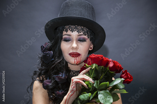 portret de fată frumoasă gotic cu trandafiri rosii. Halloween photo