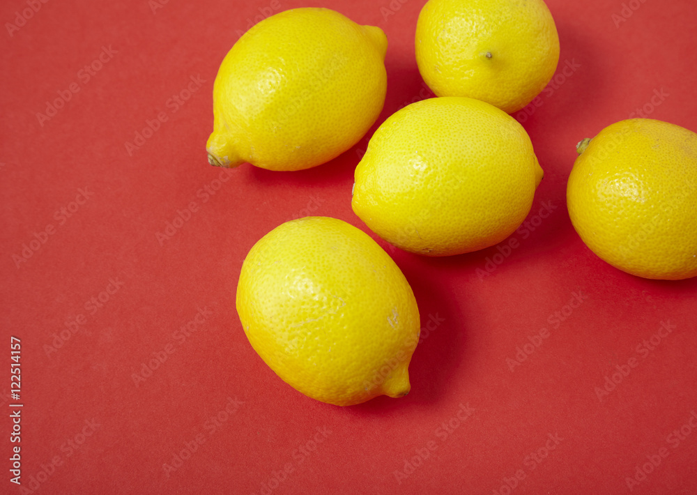 Lemons on a bright red background forming a page border Lemons on a bright red background forming a page border