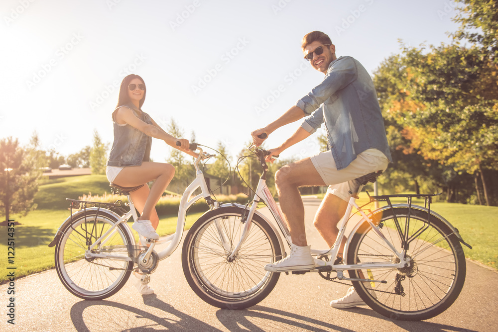 Couple cycling in park