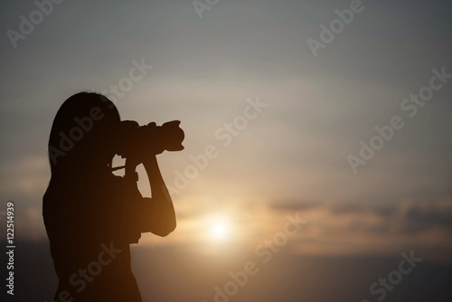 silhouette photographer woman in the sunset