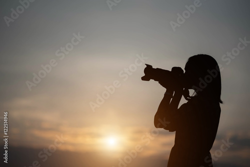 silhouette photographer woman in the sunset