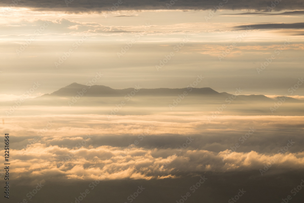 Fototapeta premium Mountain layer in morning sun ray and winter fog.