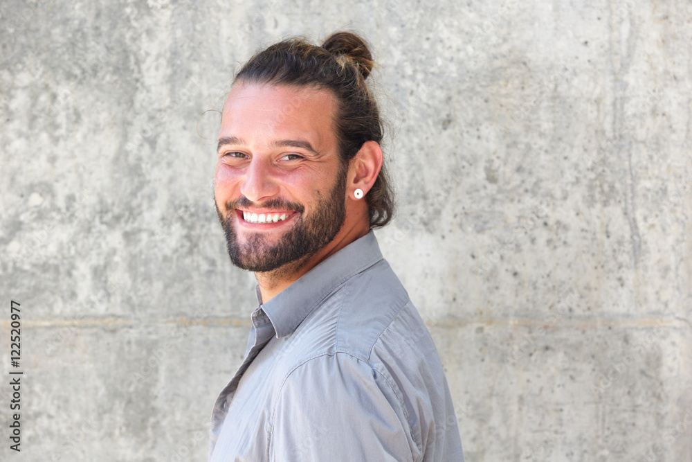 Fototapeta premium Smiling man with beard looking over shoulder