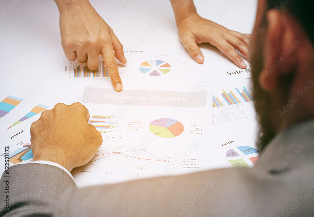 Business people during discussing financial review, business charts, point finger at graph document,after big BOSS view Business people during discussing financial review, business charts, point finger at graph document,after big BOSS view
