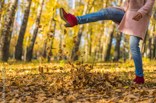 Girl kicked dry leaves