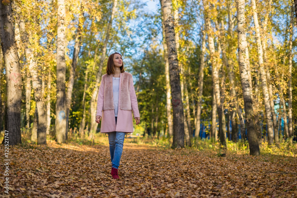 Young girl walking in the autumn forest. Young girl walking in the autumn forest.