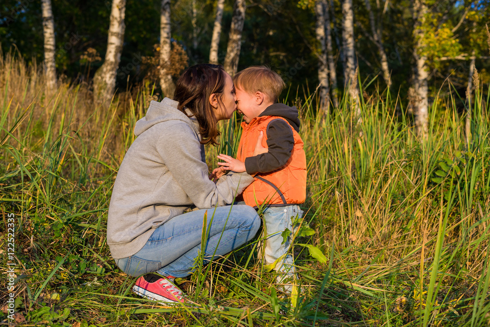Fototapeta premium Mom hugging her son, soothe a crying baby