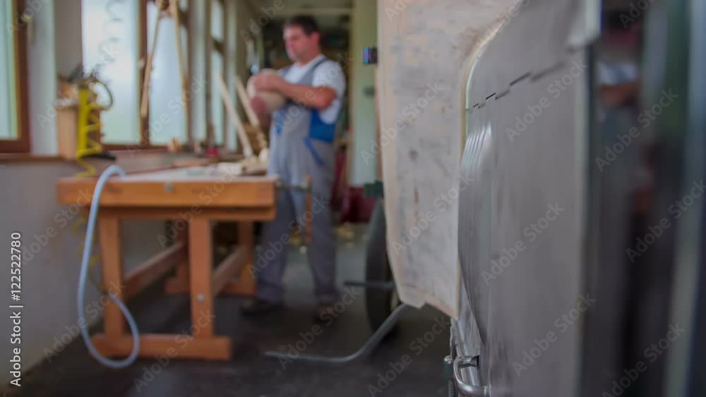A man is working in his workshop. He is making a new wooden car. Right now, he is polishing the back of the front light and then he will attach it to the car. Wide-angle shot.
A man is working in his workshop. He is making a new wooden car. Right now, he is polishing the back of the front light and then he will attach it to the car. Wide-angle shot.