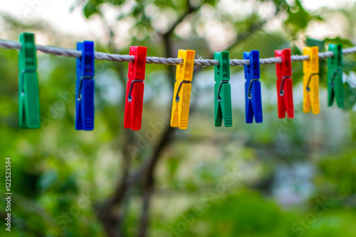 Colored clothespins for linen hanging on a rope