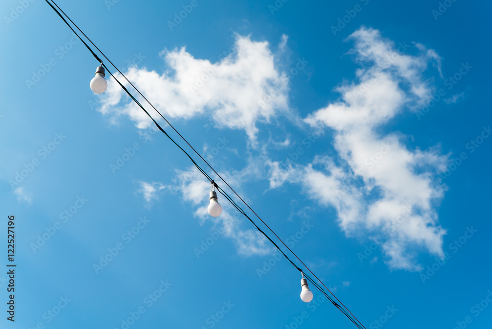 Fluorescent lamps with blue sky and cloud in background Fluorescent lamps with blue sky and cloud in background