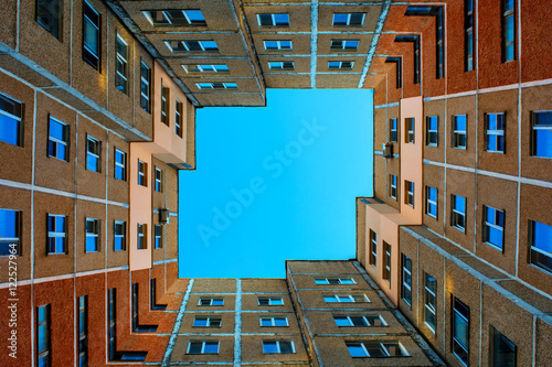 Photo of the squared building with blue sky