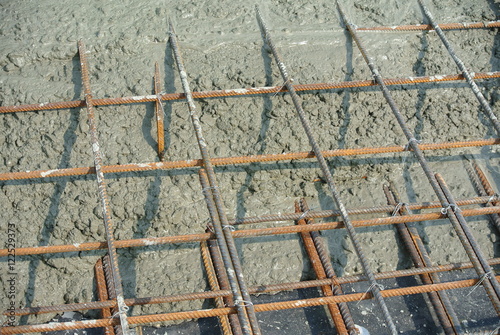 The wet concrete is poured on a steel reinforcement to form strong floor slabs.