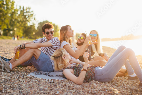 Group of friends having fun by the river  © Astarot