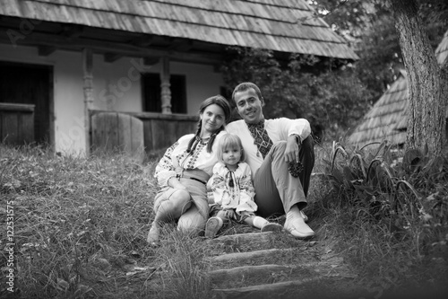 Black and white portrait of cheerful family dressed in embroider