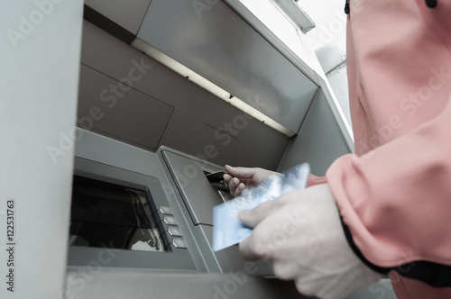 Obraz na płótnie Man at ATM machine with stash of credit and debit cards w salonie