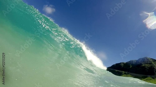 First person perspective of waves crashing in slow motion at beach. photo