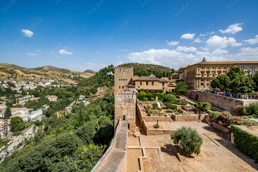 View of the Nasrid Palaces (Palacios Nazaríes) and the Palace of Charles V in Alhambra, Granada on a beautiful day, Spain 