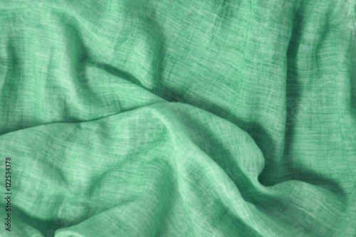 A full page of soft green linen fabric background texture 