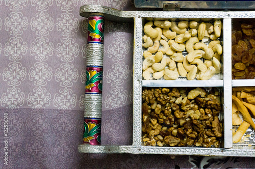 Indian snacks and dry fruits in a silver platter  photo