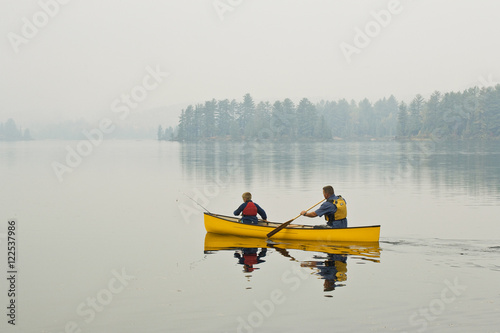 Young/middle-aged man going fishing with son on Source Lake, Algonquin Provincial Park, Ontario, Canada.