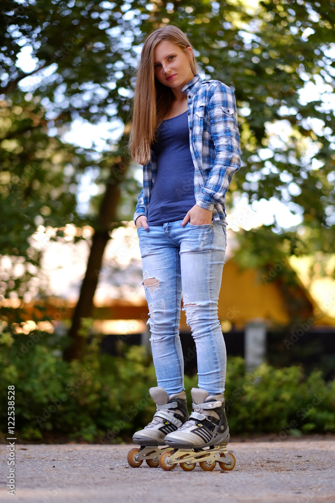 A woman in roller skates on a road. A woman in roller skates on a road.