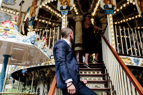 adult man and woman on a carousel