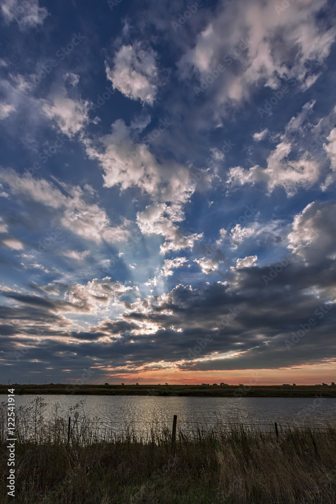 A sunrise over a small farm pond along I-90 West of Mitchell, South Dakota A sunrise over a small farm pond along I-90 West of Mitchell, South Dakota