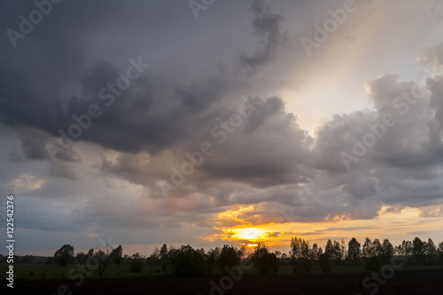 Sunset on a background of storm clouds. Bad weather, rainy weather. 