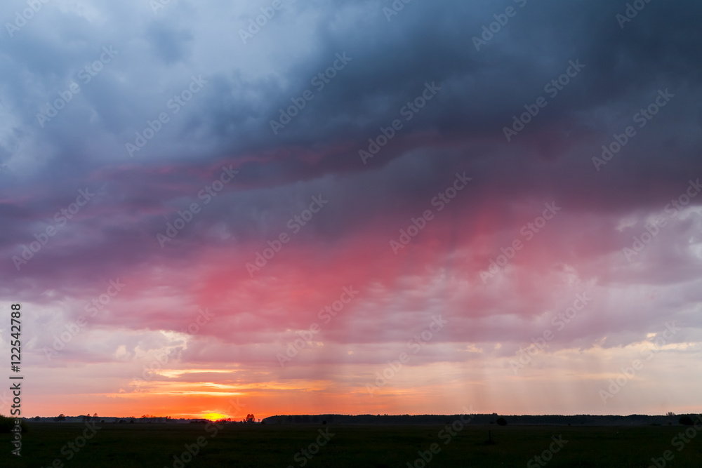 Sunset on a background of storm clouds. Bad weather, rainy weather.

