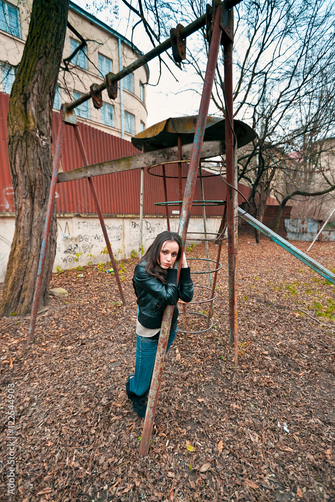 © IVASHstudio - Teenager in black leans to the swing in autumn park © IVASHstudio - Teenager in black leans to the swing in autumn park