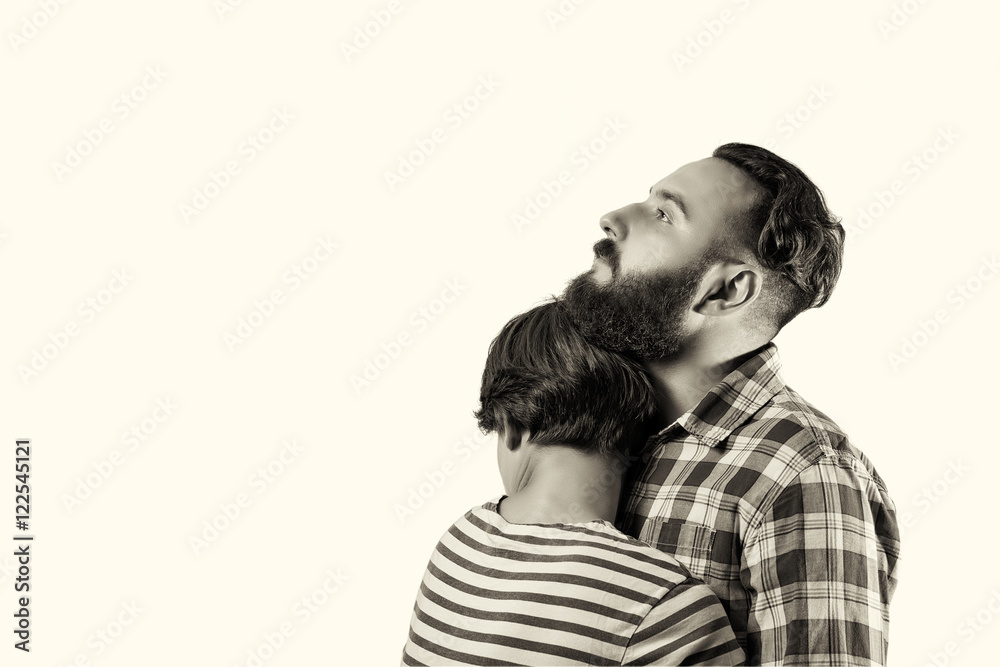 Black and white, isolated portrait of a bearded guy who hugs a girl (wife, girlfriend). The image symbolizes: care, tenderness, love, allegiance, protection ... There is a spase for your text.
