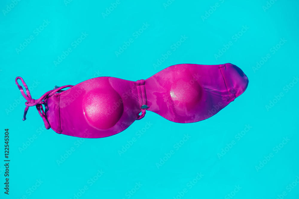 pink female swimsuit bra on water pink female swimsuit bra on water