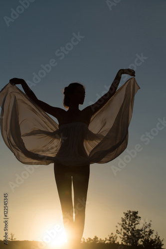 Silhouette of girl over sunset