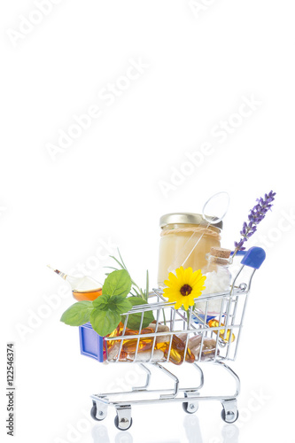 Alternative health care fresh herbal royal jelly and medicinal flower in a supermatket troley photo