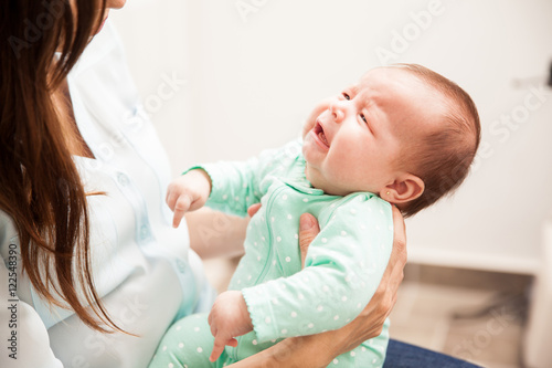 Fotografie Newborn baby pouting to her mother
