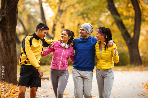 Young friends jogging at the park.Autumn season.