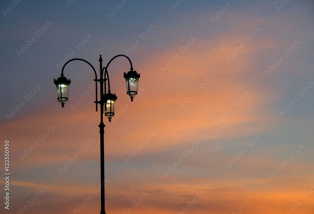 Street lamp on sunset background