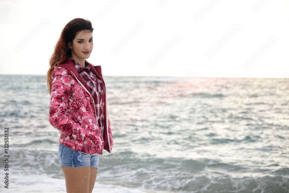 beautiful girl with colorful windbreaker walking on the beach beautiful girl with colorful windbreaker walking on the beach