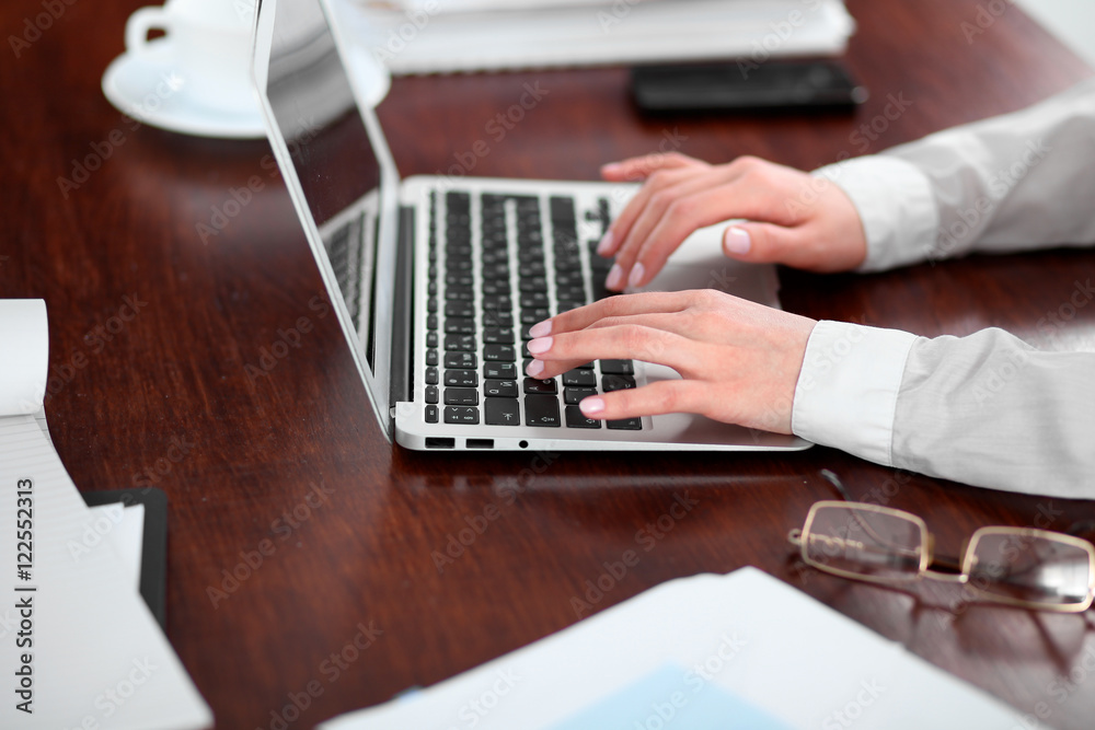 Close up of business woman hands typing on laptop computer