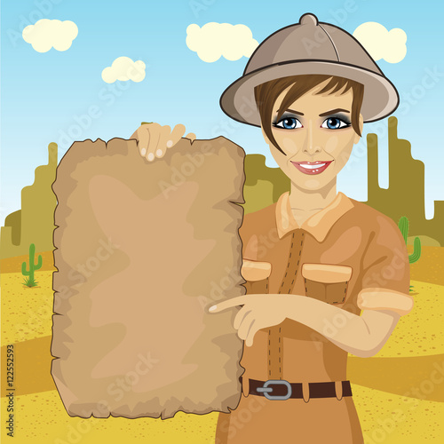 explorer woman with safari hat holding treasure map in desert