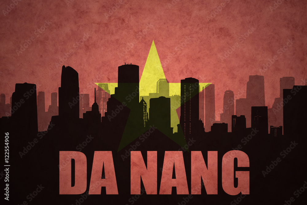 abstract silhouette of the city with text Da Nang at the vintage vietnamese flag background