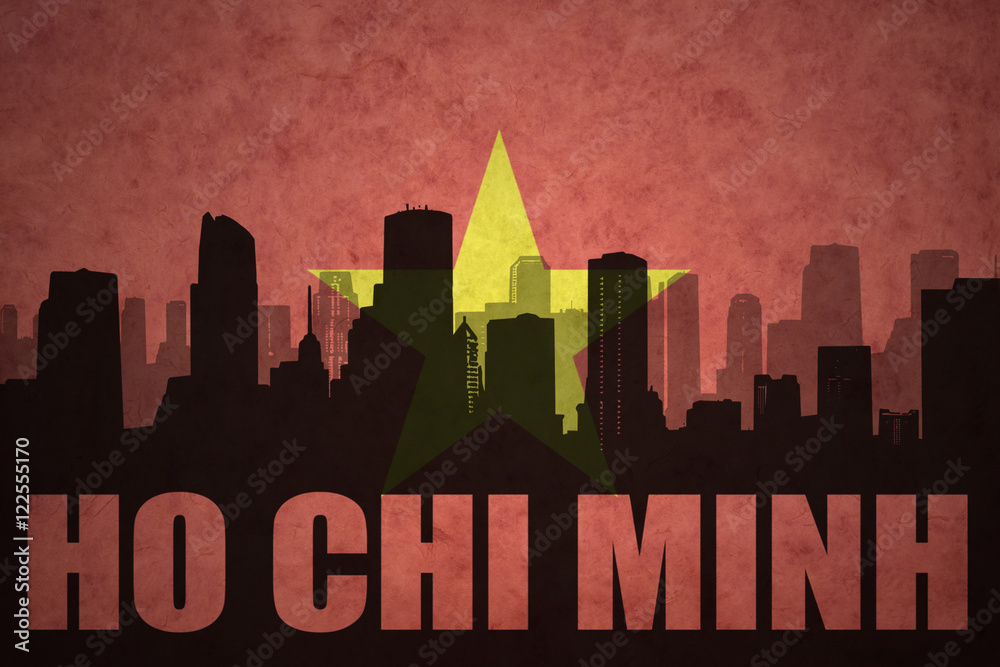 abstract silhouette of the city with text Ho Chi Minh at the vintage vietnamese flag background