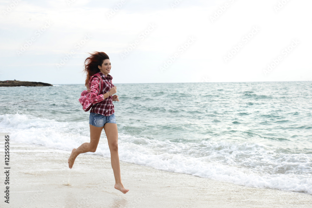 beautiful girl with colorful windbreaker running on the beach beautiful girl with colorful windbreaker running on the beach
